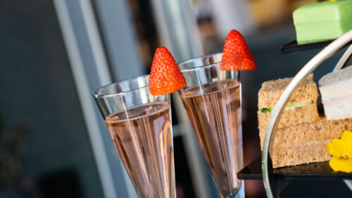 2 glasses of pink prosecco and strawberries which are served with our ultimate afternoon tea.