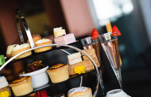 2 glasses of pink prosecco and strawberries which are served with our ultimate afternoon tea.